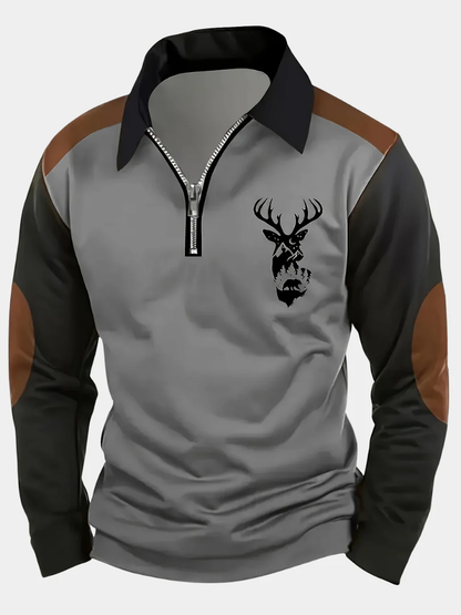 Pull col zippé gris avec manches noires, motif tête de cerf sur la poitrine.
