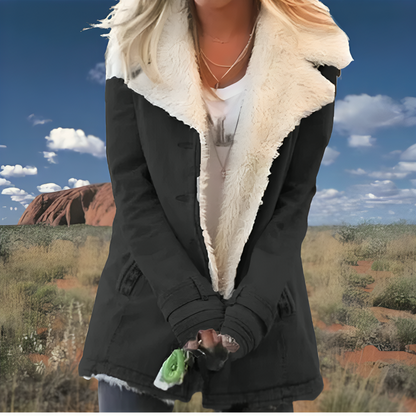 Veste noire à col en fausse fourrure beige, poignets côtelés et fermeture zippée