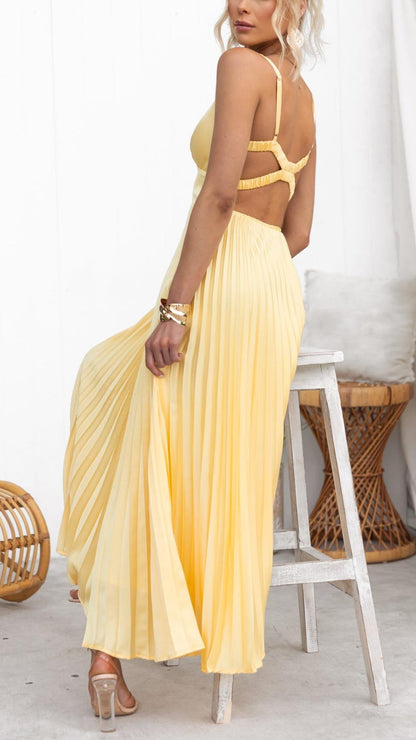 Robe longue plissée jaune, dos nu avec bretelles croisées.