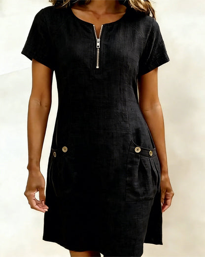 Robe courte noire avec fermeture éclair au col et poches boutonnées sur le devant