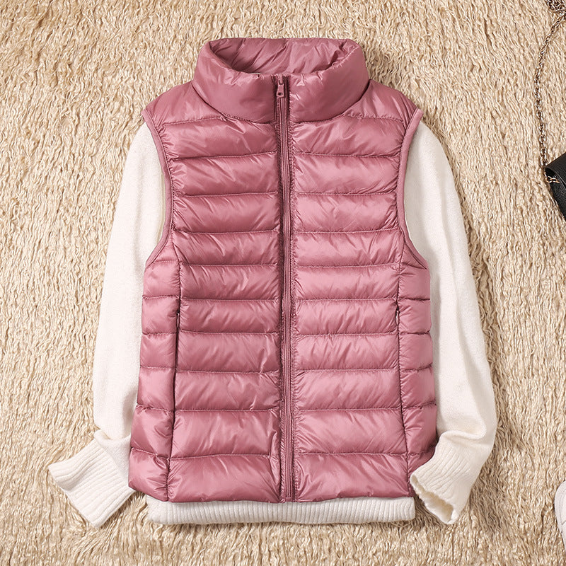 Gilet sans manches matelassé rose, fermeture zippée, col montant.