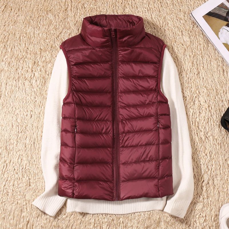 Gilet sans manches matelassé bordeaux, fermeture zippée, col montant.