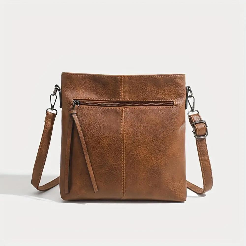 Sac à bandoulière en cuir marron avec zip central et poche zippée avant