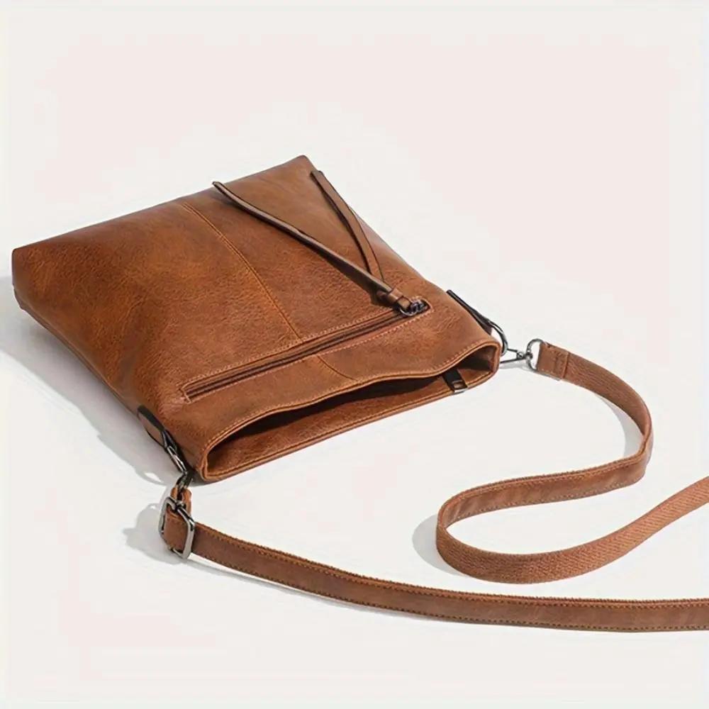 Sac bandoulière marron en cuir, rabat avant et bandoulière avec attache métallique