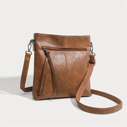 Sac bandoulière marron en cuir, deux anses et zip avant avec frange décorative