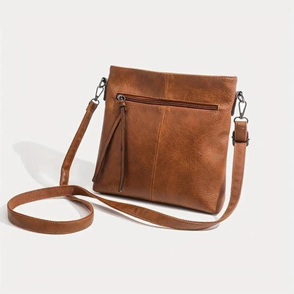 Sac à bandoulière marron en cuir, poche zippée et bandoulière réglable