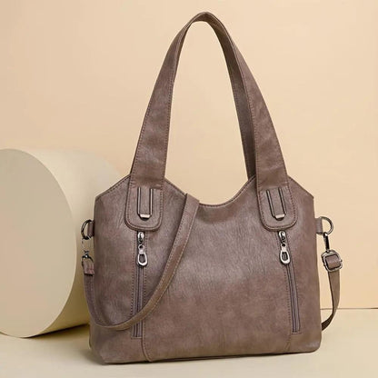 Sac à bandoulière vintage marron avec anses, bandoulière et fermetures éclair sur l’avant