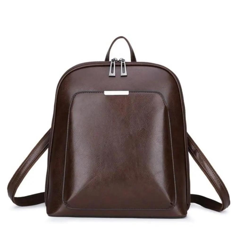 Sac à dos en cuir marron à double fermeture, poignées et bretelles réglables