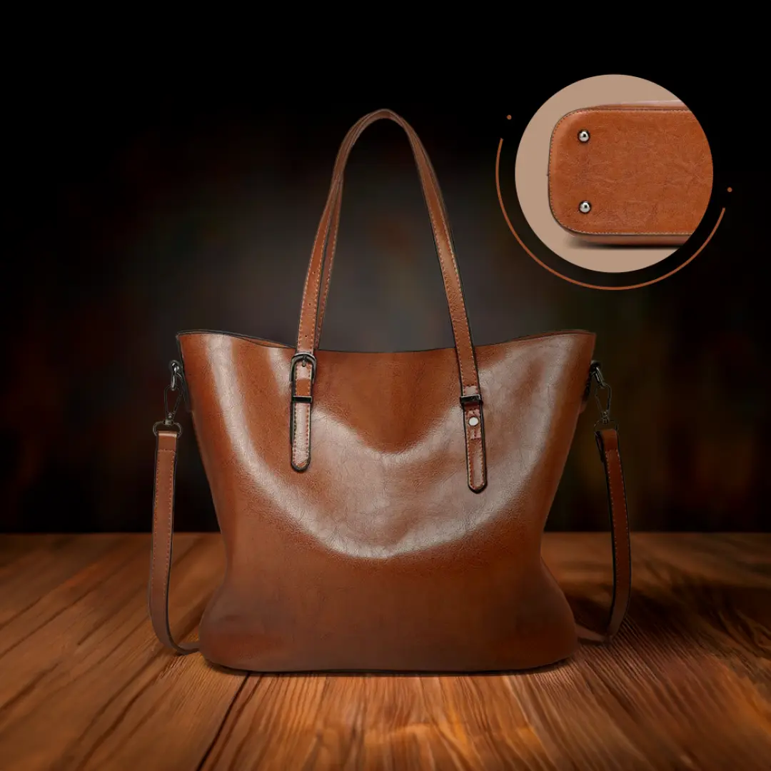 Sac à bandoulière en cuir marron, vue de face avec poches zippées et poignées