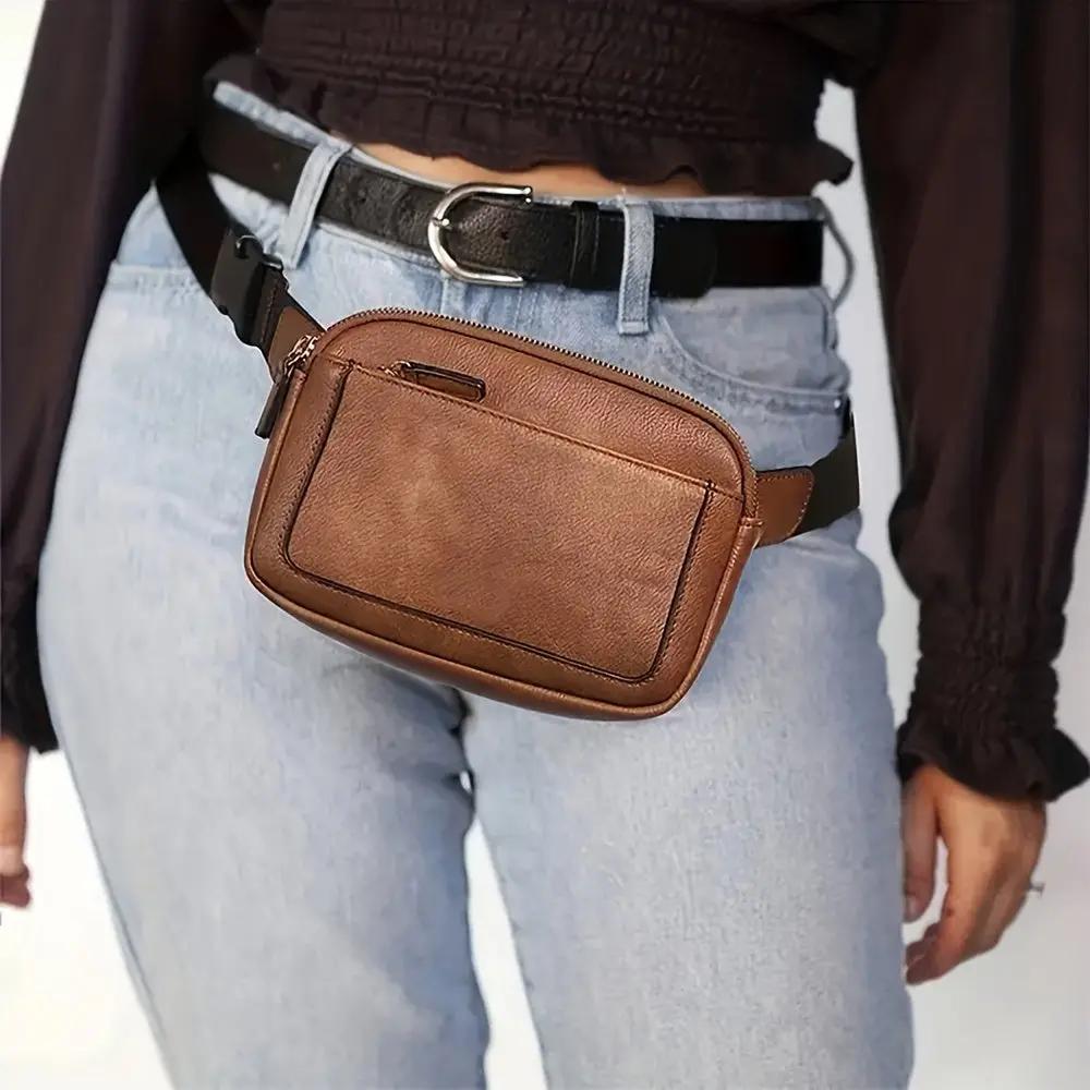 Sac bandoulière en cuir marron avec poche zippée et bandoulière réglable.
