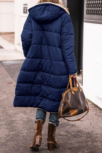 Manteau matelassé réversible à capuche, bleu marine, fermeture zippée et poches.