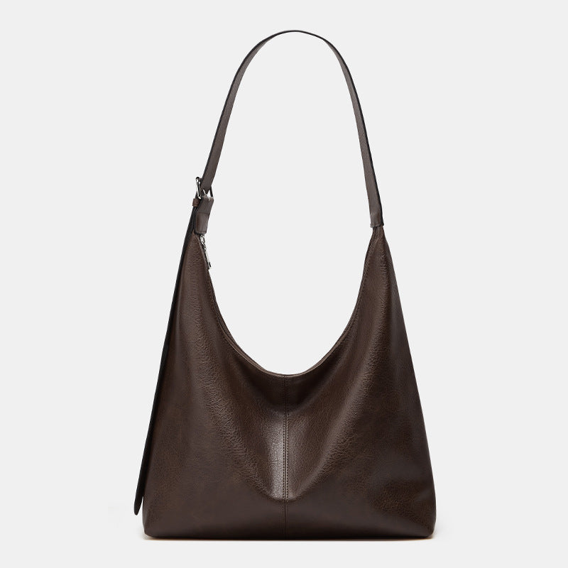 Grand sac seau en cuir marron foncé, anses courtes, surpiqûre centrale