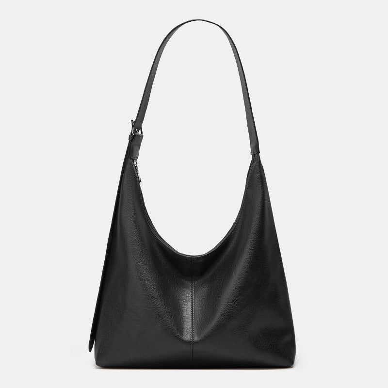 Grand sac seau en cuir noir texturé, anses courtes, surpiqûre centrale