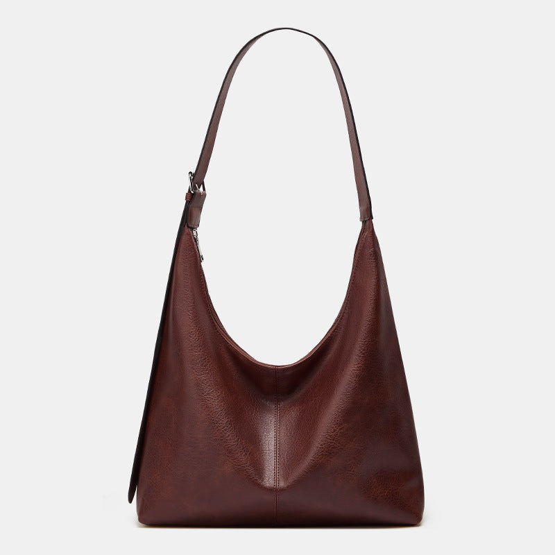 Grand sac seau en cuir bordeaux, anses courtes, surpiqûre centrale