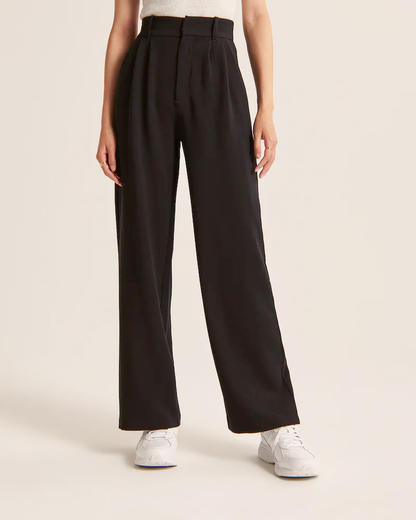 Pantalon noir taille haute à pinces, coupe ample jambes larges, longueur long.