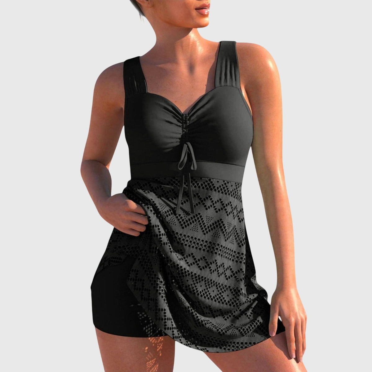 Maillot de bain deux pièces noir à jupe, motifs ajourés