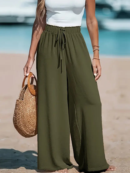 Pantalon taille haute vert olive à jambes larges, ceinture élastique avec lien central.