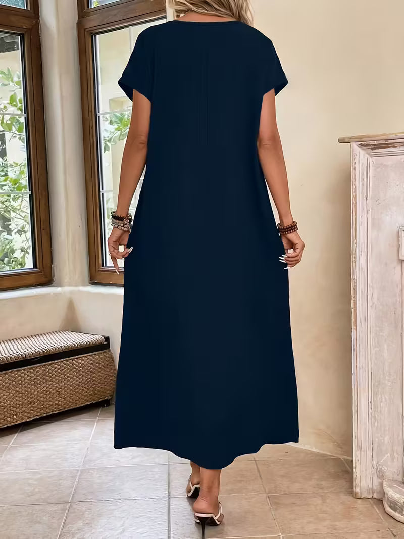 Robe longue sombre vue de dos, manches courtes, coupe droite.
