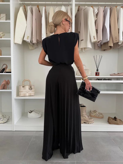 Ensemble noir : top sans manches dos nu et pantalon long à jambes larges plissées