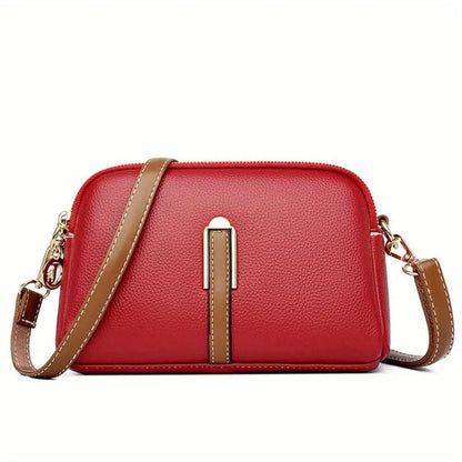 Sac bandoulière en cuir texturé rouge, bandoulière marron, fermeture zippée sur le dessus