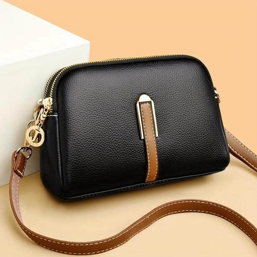 Sac bandoulière Sienne noir, poche zippée, détail lanière centrale et bandoulière