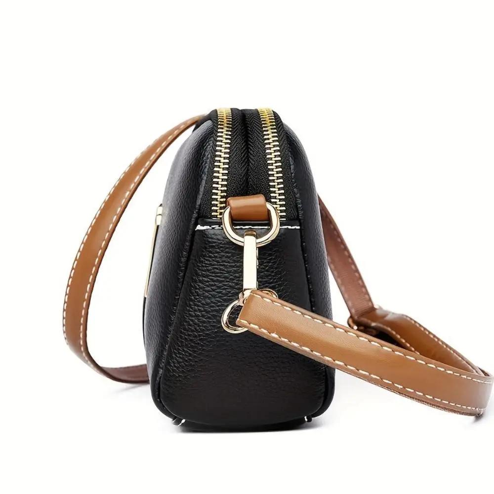 Sac bandoulière Sienne noir vu de côté, fermeture zippée, bandoulière en cuir