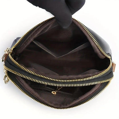 Intérieur du sac bandoulière Sienne noir avec doublure et poches zippées