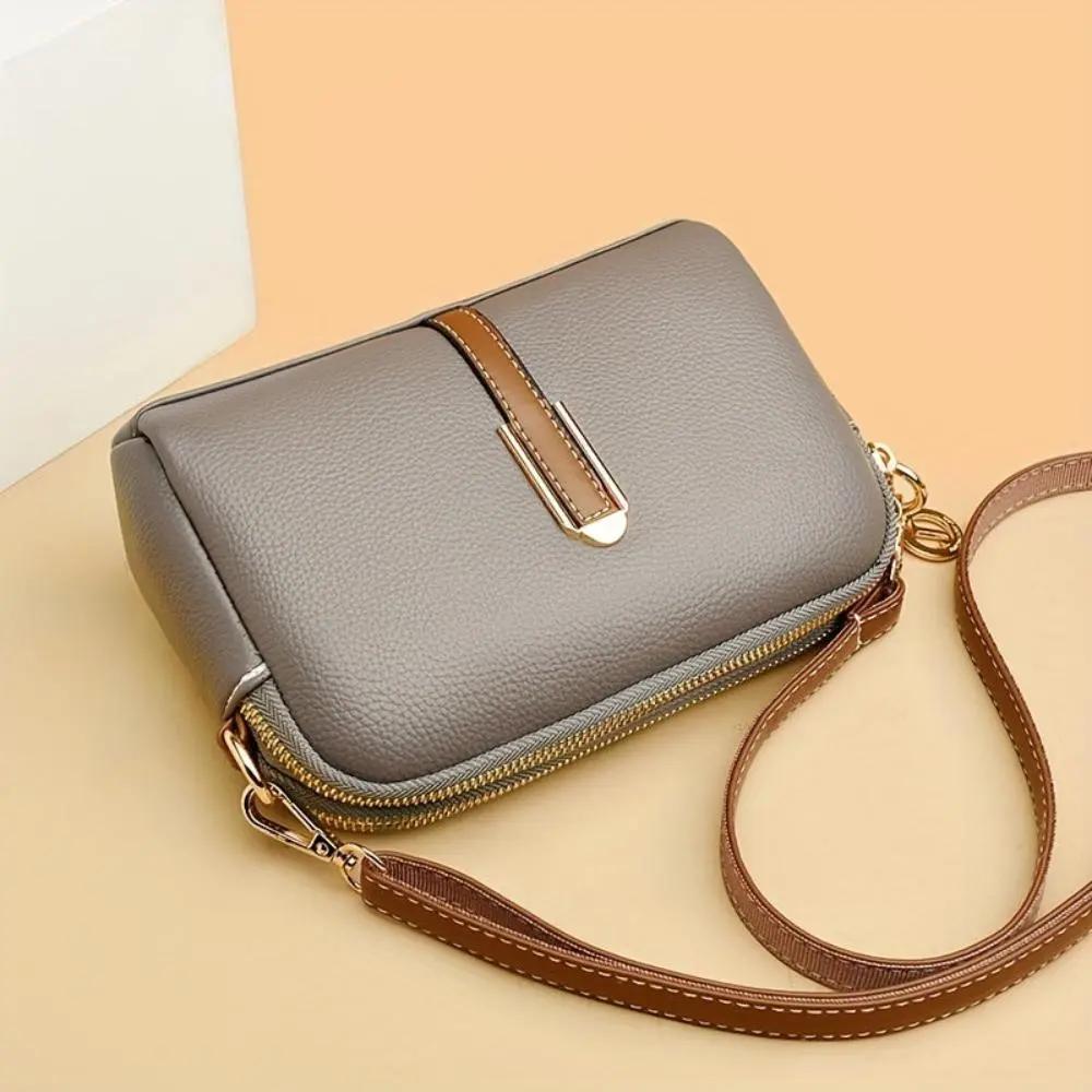 Sac bandoulière Sienne gris en cuir grainé, fermeture zippée, bandoulière marron