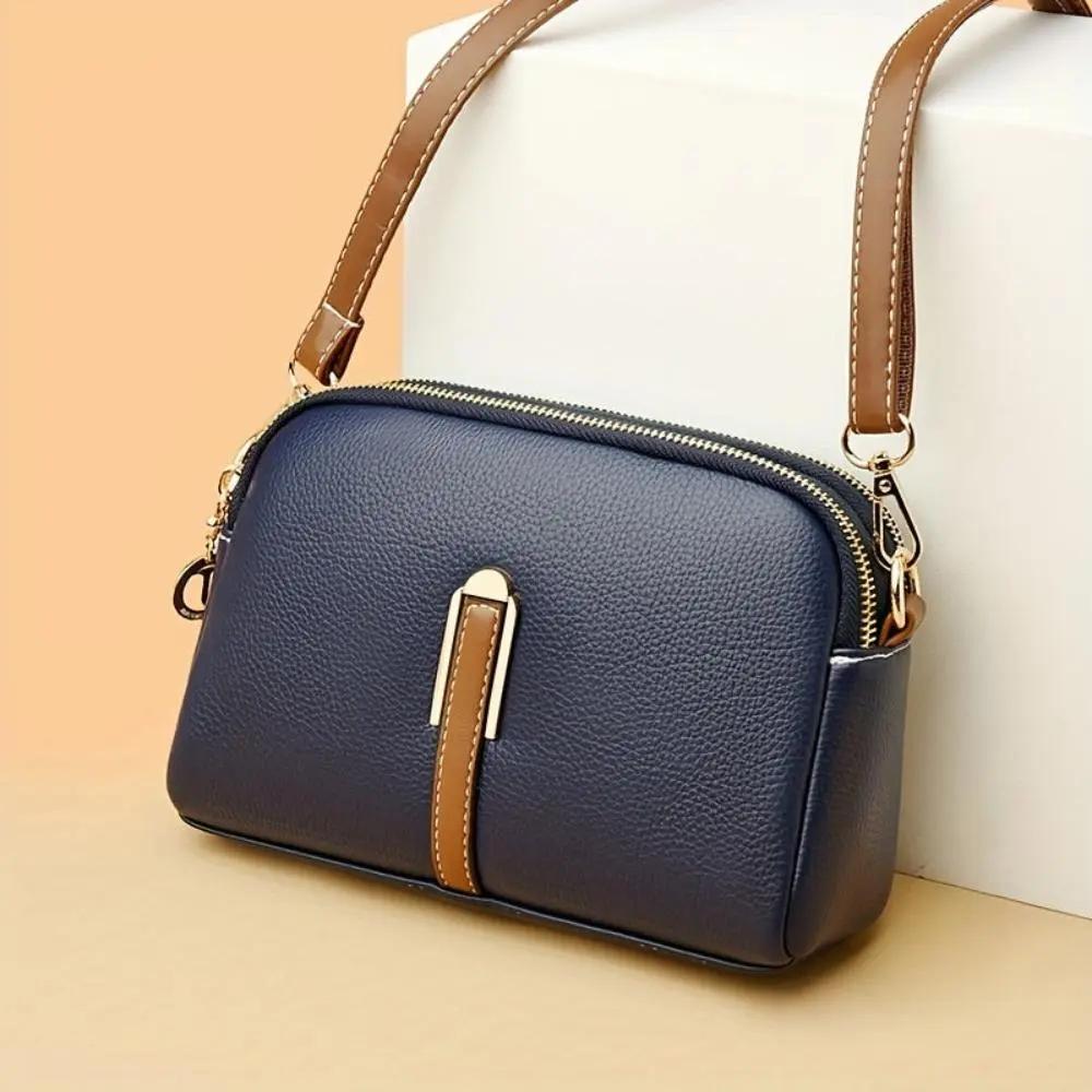 Sac bandoulière Sienne bleu nuit en cuir grainé, fermeture zippée, bandoulière marron