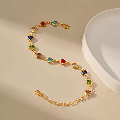 Bracelet doré aux petits cœurs émaillés rouges, bleus et verts, à plat.