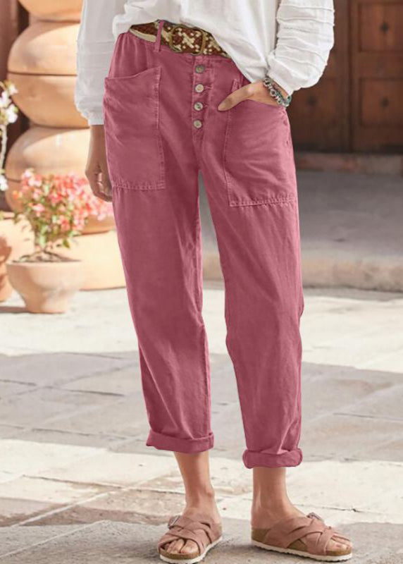 Pantalon élégant rose, pantalon 7/8, fermeture boutonnée et poches latérales.