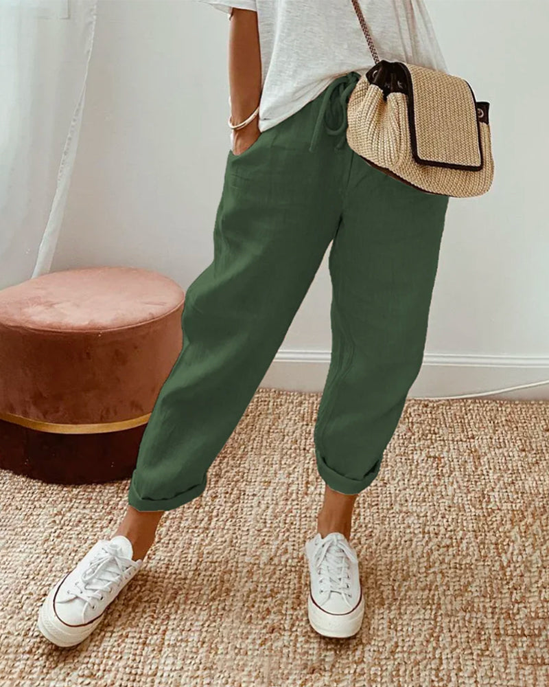 Pantalon fluide vert foncé en mélange coton et lin, coupe ample, bas élastiqué.