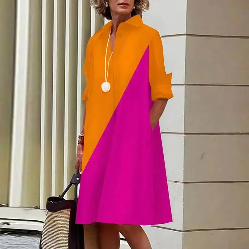 Robe mi-longue orange avec empiècement en biais fuchsia et col chemise, boutonnage.