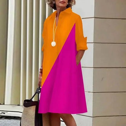 Robe mi-longue orange avec empiècement en biais fuchsia et col chemise, boutonnage.