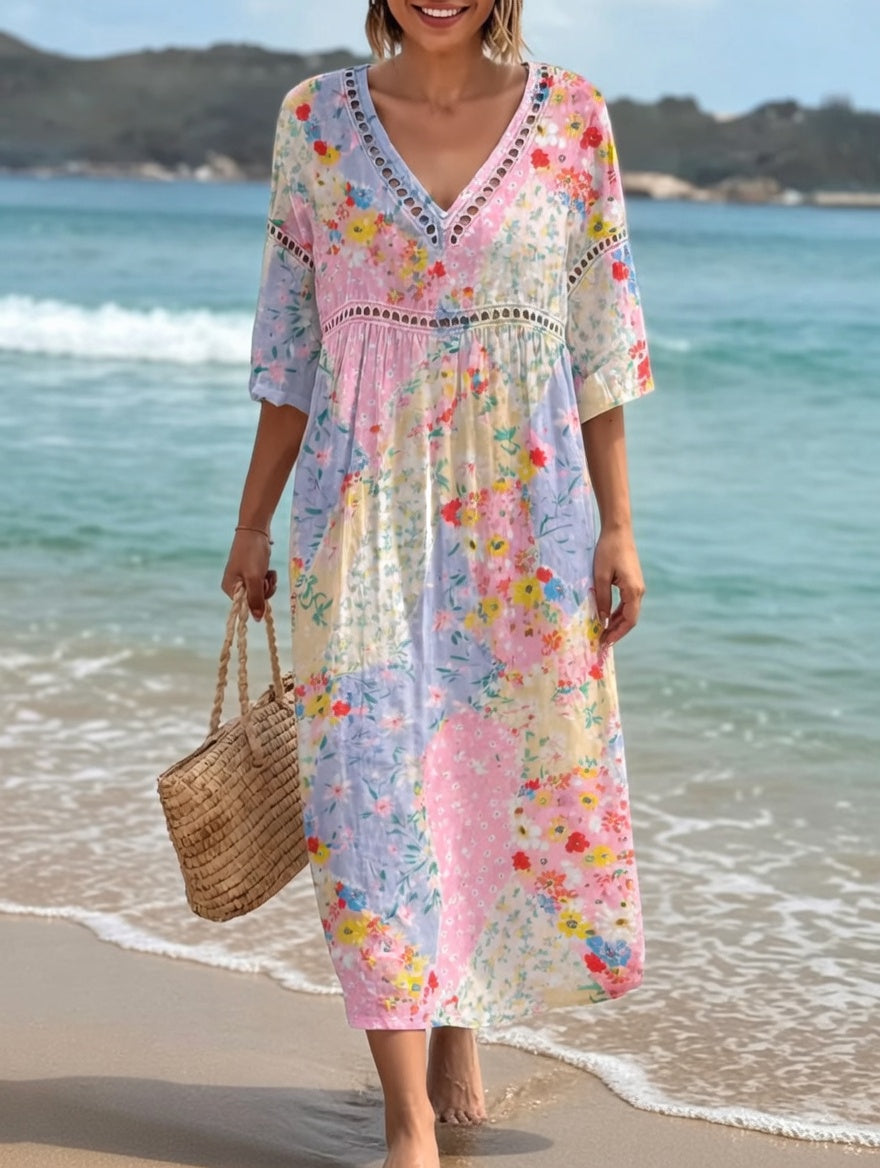 Robe fluide mi-longue, encolure V et empiècement brodé, fleurs multicolores.