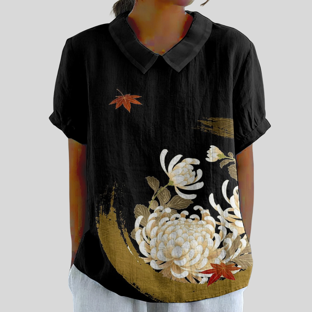Blouse noire à col chemise, manches courtes, broderie florale blanche et dorée