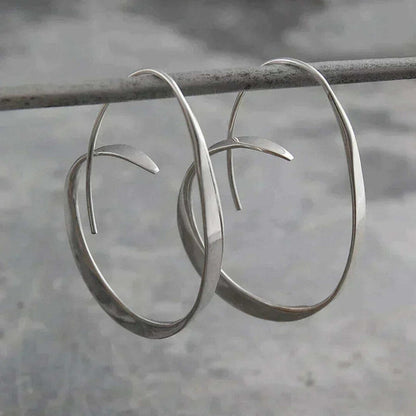 Boucles d’oreilles pendantes spirales ouvertes argent, grands anneaux ovales.