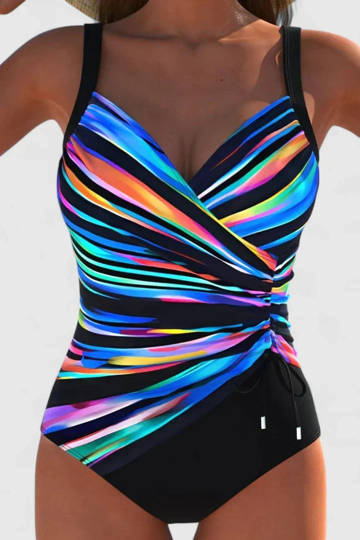 Maillot de bain une pièce multicolore à bandes, décolleté cache-cœur, liens latéraux.