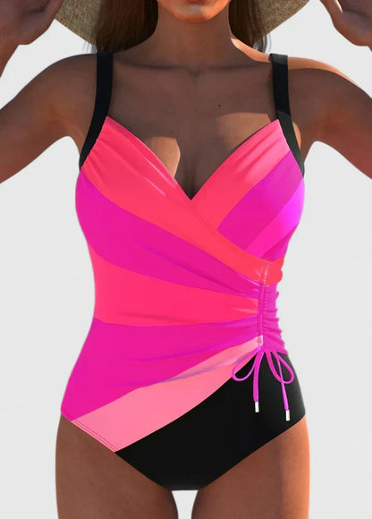 Maillot de bain une pièce rose fuchsia et noir, décolleté cache-cœur, cordons froncés.