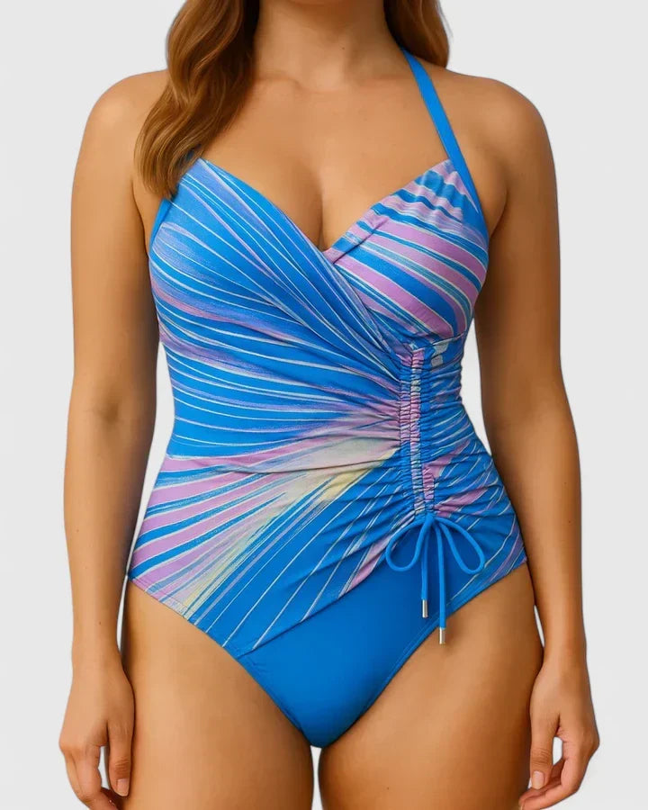 Maillot de bain une pièce rayé bleu et rose, décolleté cache-cœur, cordons à la taille.