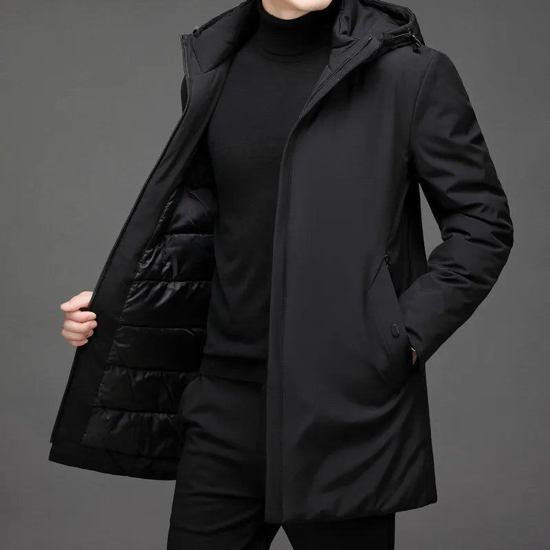 Veste longue d’hiver noire à capuche, fermeture zippée, poches latérales, doublure matelassée.