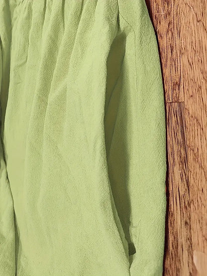 Tissu de robe vert, texture légère et couture sur le côté