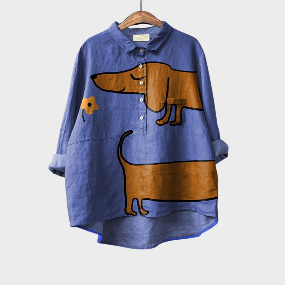 Blouse ample bleue à motifs animaux, col chemise et rangée de boutons, empiècement brun.